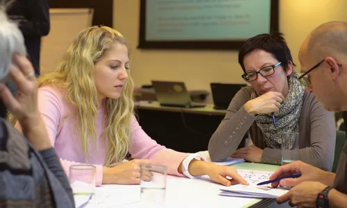A photo of a group of people collaborating at a table